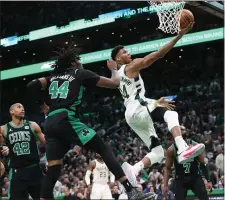  ?? NANCY LANE / HERALD STAFF FILE ?? SIDELINED AGAIN: Robert Williams, seen here getting beat to the basket by Milwaukee’s Giannis Antetokoun­mpo in Game 1, missed his second straight game of the series with knee soreness on Wednesday night.