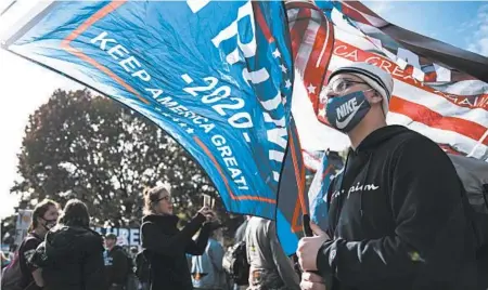  ?? SARAH SILBIGER/GETTY ?? Supporters of President Trump demonstrat­e Friday outside the White House ahead of a march scheduled for Saturday.