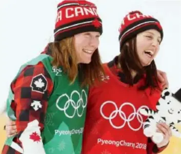  ??  ?? Silver medallist Brittany Phelan of Mont- Tremblant, Que., left, and gold medallist Kelsey Serwa of Kelowna, B. C., celebrate their success following the women’s ski- cross final at Phoenix Snow Park. Jean Levac