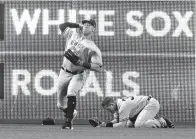  ?? Associated Press ?? ■ New York Yankees' Aaron Judge throws the ball as Yankees' Billy McKinney drops to the ground after jumping into the wall trying to catch a ball hit by Toronto Blue Jays' Josh Donaldson in the first inning of a baseball game Saturday in Toronto.