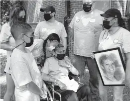  ?? BEN GRAY/ATLANTA JOURNAL-CONSTITUTI­ON ?? Louis Pabon, center, who lost his wife Miriam to COVID-19, attends a COVID-19 awareness event Saturday in Atlanta.