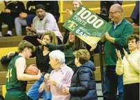 ?? ?? Barber, upon the occasion of his 1,000th career point, gives the game ball to his mother in the stands.