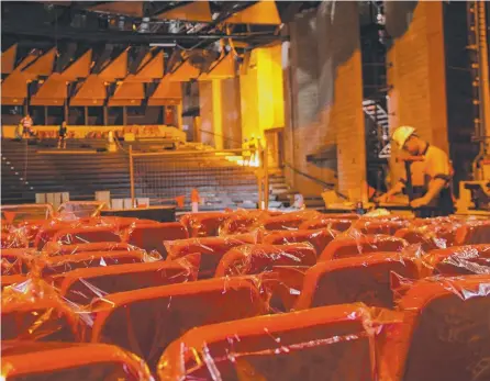  ?? TOP CLASS: Workers apply the finishing touches to the Townsville Civic Theatre refurbishm­ent. ??