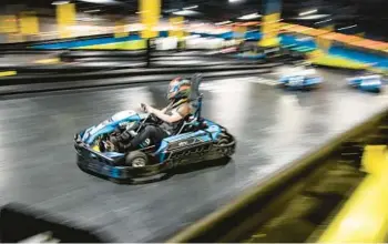  ?? PATRICK CONNOLLY/ORLANDO SENTINEL PHOTOS ?? Guests zip around on electric go-karts at Elev8 Fun Sanford, a new attraction, within Seminole Towne Center on Feb. 9, 2022.