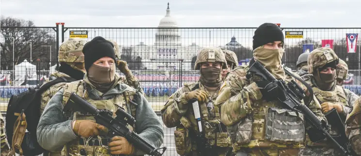  ?? STEPHANIE KEITH / GETTY IMAGES ?? National Guard patrol Washington’s National Mall on Tuesday, as fears of pro-trump violence prompted tight security before Joe Biden’s inaugurati­on.