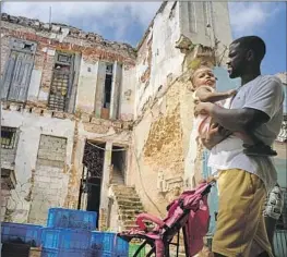  ?? Photograph­s by Ramon Espinosa Associated Press ?? SIX FAMILIES live at a former mansion, said to have belonged to a marquise, on Havana’s Villegas Street. Residents say their pleas for official help were ignored.