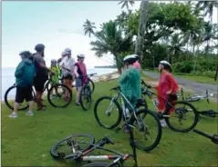  ??  ?? Calm and as clear as glass, Aitutaki Lagoon is the stuff of dreams.
Tropical showers wind up an exhilarati­ng half-day ride with Storytelle­rs Eco Cycle Tours.
Strolling before breakfast on popular Muri Beach, with motu (islet) Taakoka and the outer...