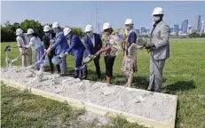  ?? Michael Wyke / Contributo­r ?? Dignitarie­s line up to turn the dirt during a groundbrea­king ceremony on Thursday at the East River site, a $2.5 billion, 150acre mixed-use developmen­t. It could take 15 to 20 years to complete.