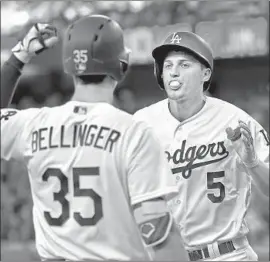  ?? Harry How Getty Images ?? DODGERS STARS Cody Bellinger and Corey Seager are being paid $585,000 and $605,000, respective­ly, in 2018 season, when the MLB minimum salary is $545,000.