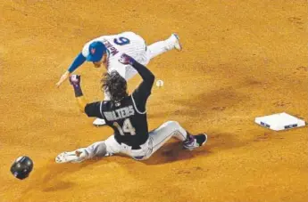  ?? Adam Hunger, Getty Images ?? Rockies catcher Tony Wolters reaches second base safely as the Mets’ Jeff Mcneil can’t handle the throw during the fourth inning Saturday night at Citi Field.