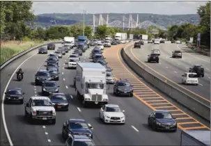  ?? The Associated Press ?? HOLIDAY TRAVEL: Traffic crawls along the westbound lanes of Interstate 287 as motorists get a jump on Memorial Day weekend on May 26 in Nyack, N.Y. A record number of people are expected to put down the TV remote and hit the road for the upcoming July...