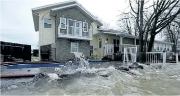  ?? JUSTIN TANG/THE CANADIAN PRESS ?? The Ottawa River is nearly level with the deck and swimming pool at Pierre Voisine’s home in Rockland, Ont., about 40 kilometres east of Ottawa, as rising levels on the Ottawa River and heavy rains continue to cause flooding, on Sunday.