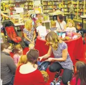  ?? FM4734155/FM4734158/FM4734167/FM4734154 ?? Ruby Davis, four, helps author Karen Stanley tell the story during her visit to Waterstone­s