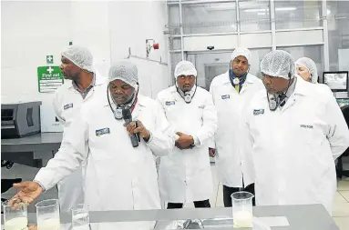  ??  ?? SWEET STAKE: Water and Sanitation Minister Gugile Nkwinti, right, is taken on a tour of the Nestle dairy factory in Mossel Bay. The factory has invested in an initiative to reduce its reliance on municipal water