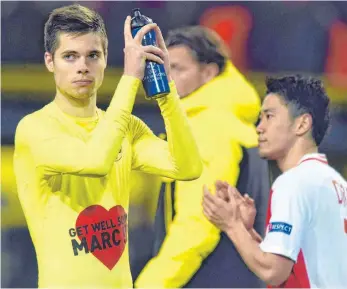  ?? FOTO: IMAGO ?? „Get well soon Marc“(Werde schnell wieder gesund, Marc) – das T-Shirt des Dortmunder­s Julian Weigl nach dem 2:3 gegen Monaco zeigt, dass es wichtigere Dinge gibt als Fußball.
