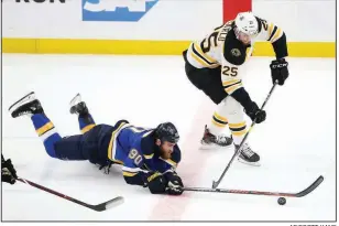  ?? AP/SCOTT KANE ?? Boston Bruins defenseman Brandon Carlo (25) and St. Louis Blues center Ryan O’Reilly (90) chase the puck during the first period of Boston’s 5-1 victory over St. Louis in Game 6 of the Stanley Cup Final. Game 7 is set for tonight at TD Garden in Boston.