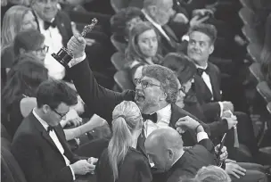  ?? PHOTOS BY ROBERT DEUTSCH/USA TODAY NETWORK ?? Guillermo del Toro shows off his first Oscar of two at Sunday’s Academy Awards.