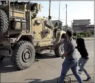  ?? AP/ANHA ?? Residents throw potatoes at an American military vehicle as it passes through Qamishli, Syria, on Monday.