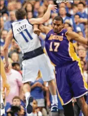  ?? PAUL MOSELEY / FORT WORTH STAR-TELEGRAM ?? Lakers center Andrew Bynum knocks down Mavericks guard J.J. Barea during a 2011 NBA playoff game in Dallas.