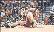  ?? COURTESY OF OSU ATHLETICS] ?? Oklahoma State's Nick Piccininni, right, wrestles Oklahoma's Christian Moody during the Bedlam dual on Sunday at Gallagher-Iba Arena. Piccininni eventually pinned Moody as OSU won 27-8. [BRUCE WATERFIELD/