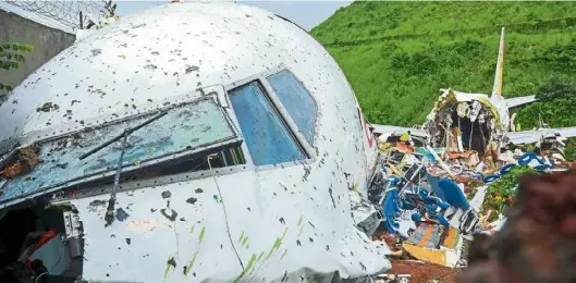  ?? —AFP ?? Deadly impact: The wreckage of the Air India Express jet at the Calicut Internatio­nal Airport in Kozhikode.