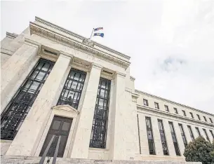  ?? ANDREW HARNIK/THE ASSOCIATED PRESS ?? The Federal Reserve board building in Washington. The central bank has scaled back its mountain of Treasury and mortgage debt by $111.9 billion since September.