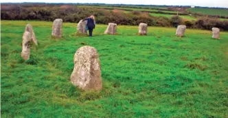  ??  ?? In this October 2011 photo provided by Maresa Thompson, Thompson examines a stone circle in Cornwall, United Kingdom.