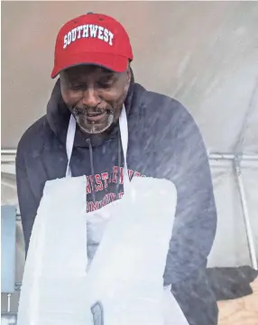  ?? ARIEL COBBERT/THE COMMERCIAL APPEAL ?? Chef Steven Leake creates the wings of the swan with his chainsaw at Southwest Tennessee Community College on Feb. 18.