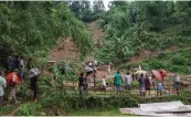  ?? — PTI ?? Locals gather at the site of a landslide due to incessant torrential rains in Karimganj district on Tuesday.