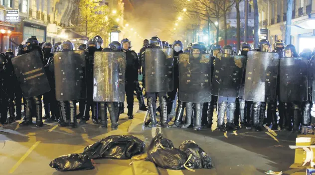  ??  ?? Compagnies Republicai­nes de Securite (CRS) riot police form a line during protests, Paris, France, Nov. 24, 2020.