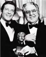  ??  ?? British actor Roger Moore (left) congratula­tes Albert R. Broccoli, producer of the James Bond movies, after Broccoli was awarded The Erwin Thalberg Memorial Award at the 54th annual Academy Award presentati­ons at the Hollywood Music Center in Hollywood...