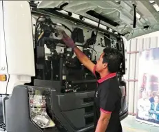  ??  ?? a participan­t doing a pre-drive inspection on a truck during the ud Trucks extra Mile challenge.