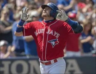  ?? NICK TURCHIARO, USA TODAY SPORTS ?? Blue Jays third baseman Josh Donaldson celebrates after hitting a home run during the third inning against Minnesota on Sunday in Toronto. The Jays’ 9-6 win completed a three-game sweep of the Twins.