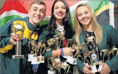  ?? Picture: WERNER HILLS ?? TOP HONOURS: Bernard Cloete, left, Leanka Laubscher and Anneke Bushby, all dancers, with some of the trophies they brought back from the Talent America competitio­n in New York