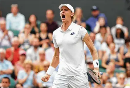  ?? Matthew Stockman / Getty Images ?? South Africa’s Kevin Anderson lets out a roar after winning a key point in Friday’s semifinal match by going to his off hand — his left — to return a shot to John Isner. Anderson won that game en route to a spot in the Wimbledon final.