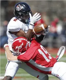  ??  ?? HOLD ON: Stoughton’s Christian Ais makes the catch while getting hit by North Attleboro’s Matt Penta in the third quarter.