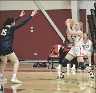  ?? ODETT OCHOA PHOTO ?? Imperial Tiger Georgia Gomez (12) looks to pass against the Yuma Catholic Shamrocks during a non-league girls basketball game on Wednesday, February 1, at the Tigers’ gym in Imperial.