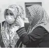  ?? Associated Press ?? Women look at the destroyed building where they lived in Turkey on Saturday.