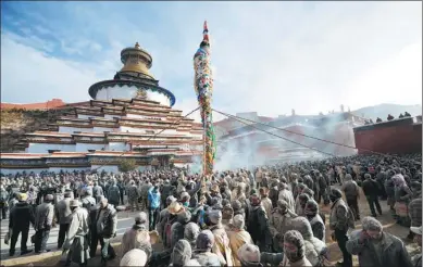  ?? JIKME DORJEE/ XINHUA ?? People pull ropes tied to a pole with prayer flags to keep it erect during an annual event in Xigaze, Tibet autonomous region, on Sunday. About 10,000 residents attended the event to pray for a bumper harvest and a happy life.