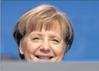  ?? AP PHOTO ?? German Chancellor and party chairwoman Angela Merkel smiles at the party convention of the Christian Democratic Union CDU in Berlin. The members of the Social Democratic party voted for a coalition agreement with Merkel’s party paving the way for...