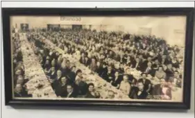  ?? COLIN AINSWORTH - DIGITAL FIRST MEDIA ?? The Keystone Club of Chester’s 1953 banquet is one of many pictures hanging in the masonic temple, showing hundreds gathered in the cafeteria/auditorium. Chester Lodge often hosted outside civic events at the temple.