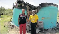  ?? Picture: MALIBONGWE DAYIMANI ?? DEVASTATIN­G EXPERIENCE: Lungisile Fadeshe, holds his 100-year-old grandfathe­r Gashe Tinana, who has been left traumatise­d after his wife burnt to death in front of him