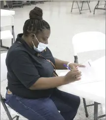  ?? Brodie Johnson • Times-Herald ?? The Vaccine Clinic at the Forrest City Civic Center was a big success, according to officials with the St. Francis County Health Unit. Michelle Hillard fills out paperwork before recieving her dose of the vaccine.
