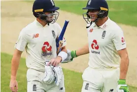  ?? GETTY IMAGES ?? Solid start: Ollie Pope (left) and Jos Buttler leave the field