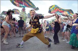  ?? ELIZA GREEN / THE CALIFORNIA­N ?? Lightning in a Bottle attendee Charlie Dando shows off his dance moves at the Woogie section of the Lightning in a Bottle music festival on Friday.