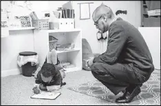  ?? CONTRIBUTE­D ?? Benjamin Wills, founder of the Peace Preparator­y Academy in Atlanta, looks on as a student completes a class assignment. Peace Prep opened in 2015 with 12 kindergart­ners and will add a class until it is a full K-12 school.