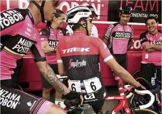  ??  ?? Jetse Bol enjoys some down time on the team's borrowed bus. The team sta f plot their next tactical move. Hernan Aguirre speaks to the press - he inished as the team's highest placed rider overall. Former rider Jarlinson Pantano stops by the bus to...