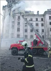  ?? AP ?? Firefighte­rs work at the site after a Russian attack in Kyiv, Ukraine, on Thursday.