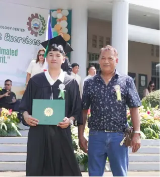  ?? ?? DANIEL Rey Celso, one of APRI’s scholars at Don Bosco, proudly received his diploma with his father, Henry Celso.