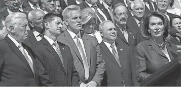  ?? WIN MCNAMEE WIN MCNAMEE, GETTY IMAGES ?? House Democratic leader Nancy Pelosi, right, and House Speaker Paul Ryan, second left, lead Congress’ observance on Friday of the anniversar­y of the terrorist attacks on Sept. 11, 2001.